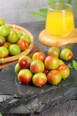Fresh Ripe Plums on Slate Board with Juice Glass - Healthy Organic Fruit Display
