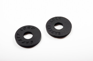 Round black rubber safety lock for guitar strap.
