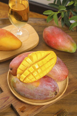 Fresh Rainbow Toffee Mangoes from Hainan Guangxi China on Wooden Table with Wine Glass