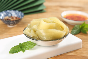 Fresh Handmade Potato Noodles with Mint and Dipping Sauce on Wooden Board