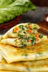 Handmade vegetable pancakes with leek and egg filling for healthy breakfast meal
