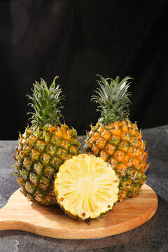 Fresh Zhanjiang Xuwen Pineapples with Sweet Golden Flesh on Wooden Board