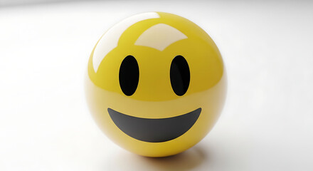 A bright yellow smiley face emoticon with black eyes and a wide smile sits on a white surface.