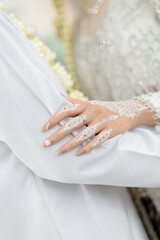 Bride&rsquo;s Hand with Henna Resting on Groom&rsquo;s Arm