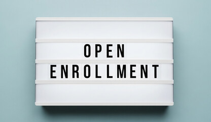 Open Enrollment period announcement on a modern lightbox sign with a blue background