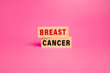 breast cancer words text on wooden blocks isolated on pink background. women health issues