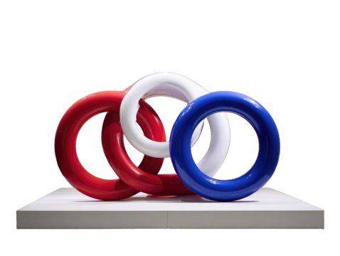 Red, white, and blue rings on a white plinth