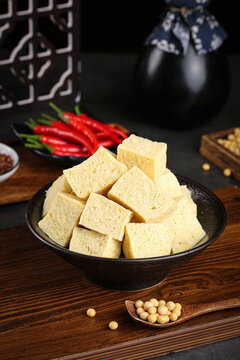Raw tofu cubes with soybeans and chili peppers on wooden table for Asian cooking