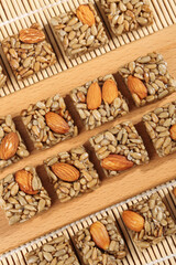 Handmade Nut Seed Candy Bars with Almonds Sunflower Seeds on Wooden Board Healthy Artisanal Snacks