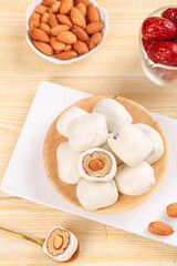 Handmade Steamed Buns with Almond Filling and Dates on Wood Background