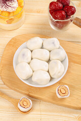 Handmade Cheese Dumplings with Dates and Traditional Sweets on Wooden Board
