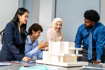 Group of multicultural architect business team people on meeting looking model and design of new real estate house, working towards their shared goals, Experts look at model homes