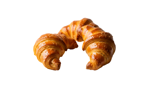 Three Argentine croissants placed on a plate against a white backdrop

