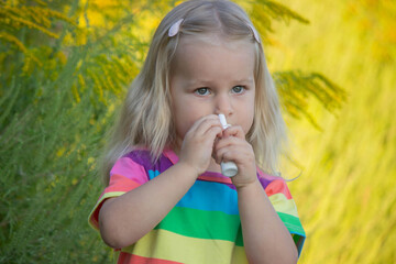 Girl in rainbow shirt with ragweed allergy
