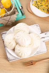 Fresh Handmade Steamed Pork Buns with Noodles and Citrus on Rustic Wooden Table