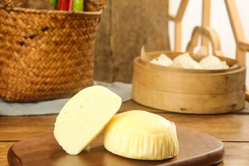 Fresh Handmade Cheese Treats on Wooden Plate in Traditional Kitchen Setting