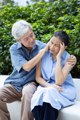 Naklejka premium Senior husband taking good care of his depressed wife with headache, concept of old-aged husband caring his wife, elderly couple and family health care lifestyle