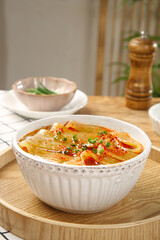 Handmade Sichuan Spicy Noodles in Bowl with Chili Oil and Scallions - Traditional Chinese Hot Pot Cuisine