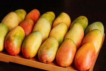 Fresh Hainan Princess Mangoes in Wooden Crate - Sweet Tropical Fruit Harvest Display