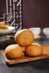 Traditional Chinese Handmade Pastry Puffs on Wooden Board in Tea House Setting