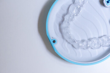 clear aligners device in the mouth on a white background. (invisalign)	

