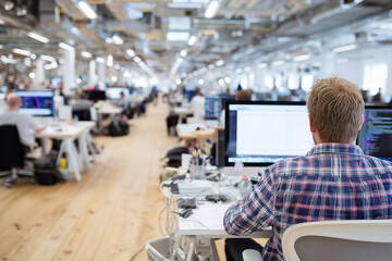 Modern open-plan office filled with creative professionals at work, 