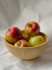 Autumn apples in a wooden bowl