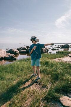 Child in virtual glasses vertical shot