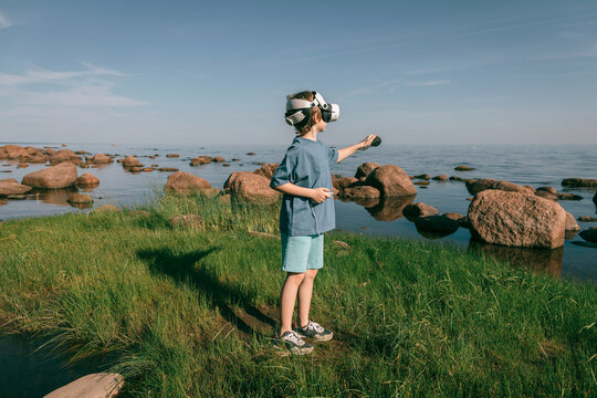 Child in virtual glasses in virtual world