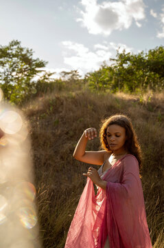 African American woman in the sun and glare in nature