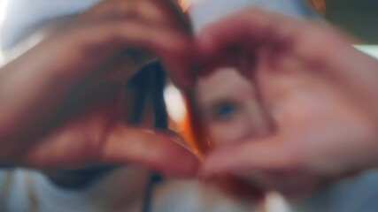 Symbol of love, black man and caucasian woman holding palms in heart shape. Happy interracial marriage, diverse people celebrating christmas together, feel happiness, joy and love, closeup of palms
