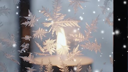 Delicate ice crystal patterns on a window, softly illuminated by a blurred warm candle flame, capturing a peaceful, cozy winter scene with falling snowflakes. - Powered by Adobe
