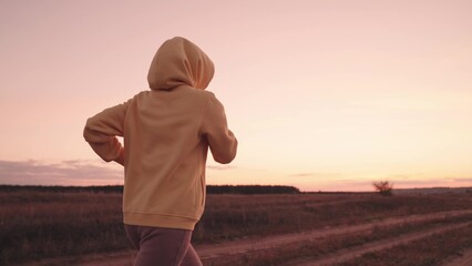 jogging at sunset, girl runs at dawn, healthy lifestyle, cardio for the heart, life in motion, sports person monitors health and body, actively engage in outdoor nature, physical energy training