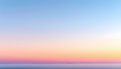 Fototapeta premium Soft dawn sky over flat horizon faint ground haze wide wallpaper background representing landscape light suitable for natural atmospheric design