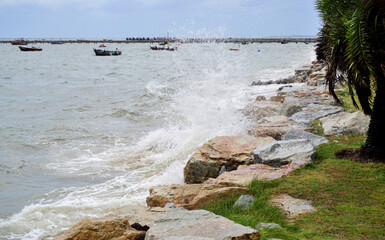 Splashing sea surf hitting rocks on the beach