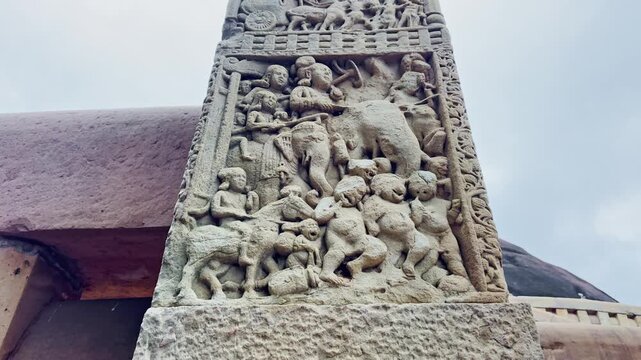 As the camera tilts upward, the Torana of Sanchi Stupa reveals layered stone carvings of elephants, people, chariots, and symbols, narrating Buddhist stories through timeless artistry