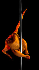 Whole chicken posed on pole with dramatic orange light against dark background. Concept of surreal...