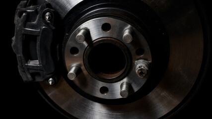 Close-up of exposed brake disc and caliper from disassembled public transport vehicle