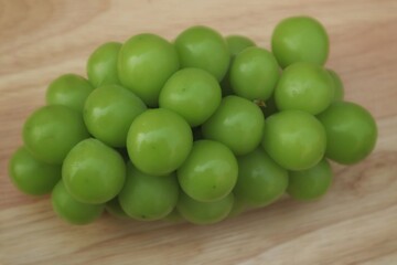 Fresh Shine Muscat or Vitis grapes close up, isolated on pink background.