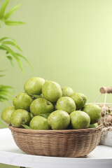 Fresh Green Walnuts in Wicker Basket - Healthy Organic Food Still Life