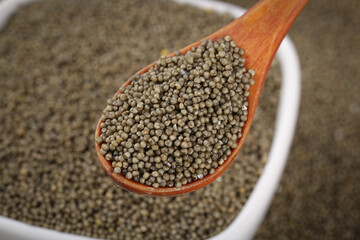 Organic Coriander Seeds in Wooden Spoon - Natural Spice Ingredient for Healthy Cooking and Traditional Medicine