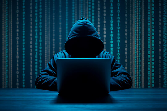 Anonymous hacker in a hooded sweatshirt working on a laptop with a digital data stream background