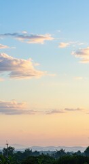 Naklejka premium Sky and Horizon at Sunset: A breathtaking view of the twilight sky over a tranquil landscape, captured as the sun dips below the horizon, offering a symphony of pastel hues. 