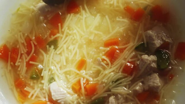 Delicious chicken noodle soup with vegetables. The concept of homemade food. High quality 4k footage