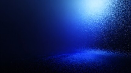 A dark, textured room illuminated by a bright, cool blue light emanating from above, creating a dramatic and atmospheric spotlight effect