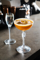 A lovely cocktail with passion fruit complements a sparkling drink, inviting enjoyment