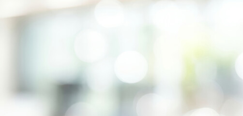 Abstract blurred background with bokeh effect in white and light colors, softly glowing to create a dreamy serene ambience filled with airy luminous highlights.