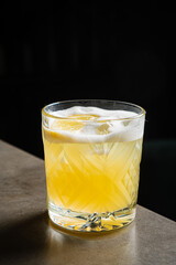 Refreshing citrus drink with ice and lemon, enjoyed in a cozy bar setting during the night