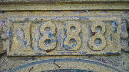 Historic stone engraving of the year 1888 in an aged architectural structure