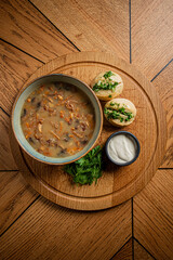 Enjoy a rich bowl of mushroom soup with herbs, dumplings, and yogurt—ideal for sharing!